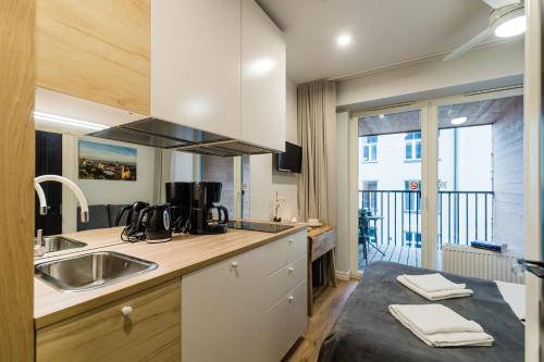 a kitchen with a sink and a counter top at Thomas' Home - Trendy, Central & Balcony in Tallinn