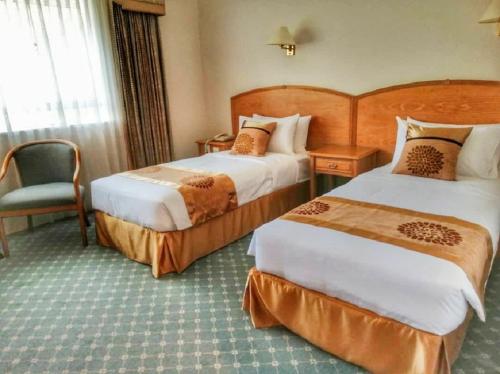 Un pat sau paturi într-o cameră la Terrace Hotel
