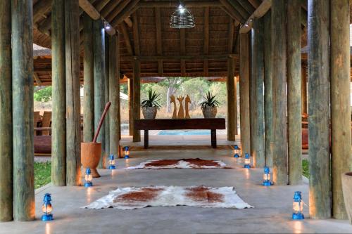 a room with a table and a rug on the floor at Fathala Wildlife Reserve in Toubakouta