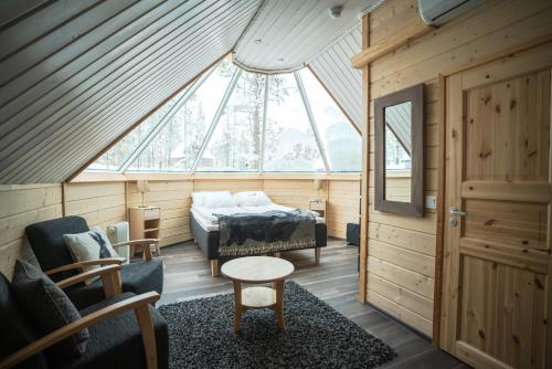 Habitación pequeña con cama y ventana en Northern Lights Village Saariselkä, en Saariselkä