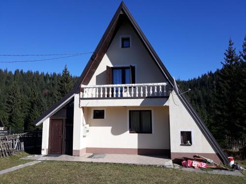 a white house with a gambrel roof at Kuća Janjic Jahorina in Jahorina