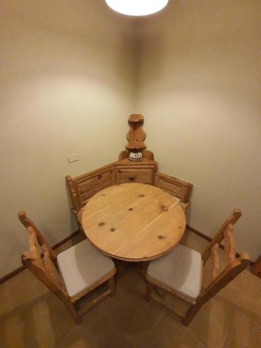 a wooden table and chairs in a room at Casa Andreola in Valfurva