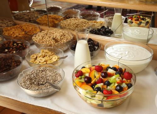 a table topped with bowls of fruit and other desserts at Hotel Garni Sonnblick in Bad Kleinkirchheim