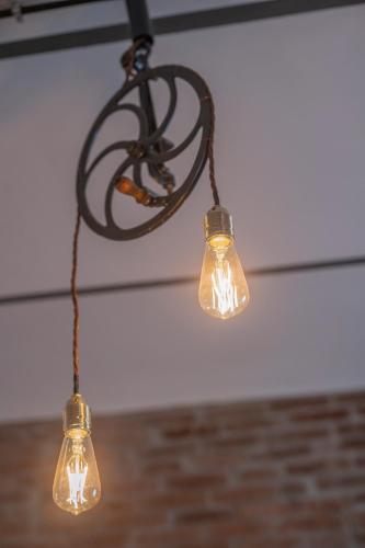 a couple of lights hanging from a ceiling at Carrara Bella in Carrara