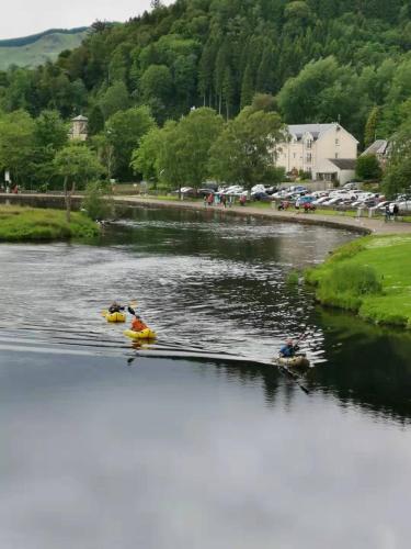 two people in boats on a body of water at The Caledonian Thistle Hotel in Callander
