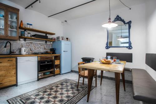 a kitchen with a table and a blue refrigerator at Carrara Bella in Carrara