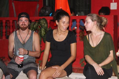 a group of three people sitting on a bench at Mitra Hostel in Arambol