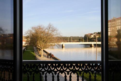 a view of a river from a window at A Rendilheira Charm Suites in Vila do Conde