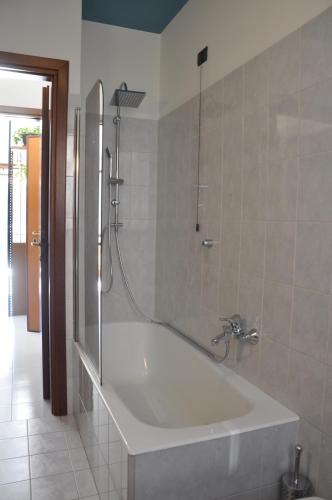 a bathroom with a bath tub with a shower at Casa Marisa in Lovere