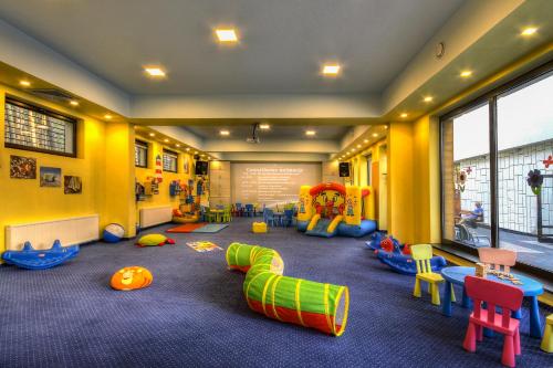 a room with many different types of play equipment at Columbus Rowy in Rowy