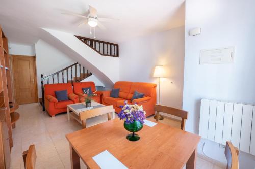 a living room with a table and orange chairs at Casa María in Nerja