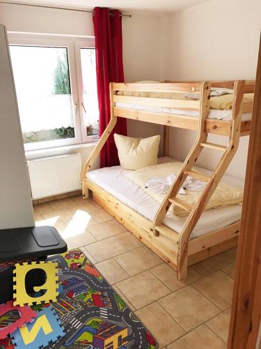 a bunk bed with a ladder in a room at Haus Seestern mit Strandkorb inkl in Göhren