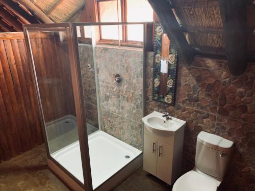 a bathroom with a shower and a toilet and a sink at Makhato Bush Lodge 111 in Bela-Bela