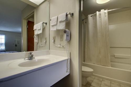 a bathroom with a sink and a shower and a toilet at Key West Inn - LaFayette in LaFayette
