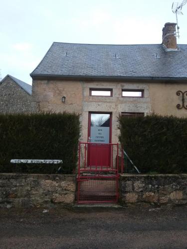 a house with a red gate in front of it at Les petites Fourches in Saint-Brisson