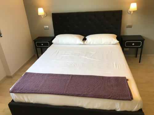 a bedroom with a large bed with two night stands at Villa Sofia in Baveno
