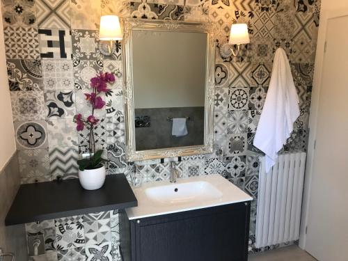 a bathroom with a sink and a mirror at Villa Sofia in Baveno