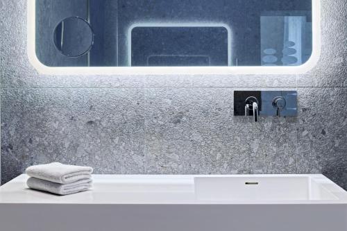 a bathroom with a white sink and a mirror at Ausonia Hungaria Wellness & Lifestyle in Venice-Lido