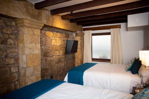 Voodi või voodid majutusasutuse Casa Villamil Boutique Hotel toas