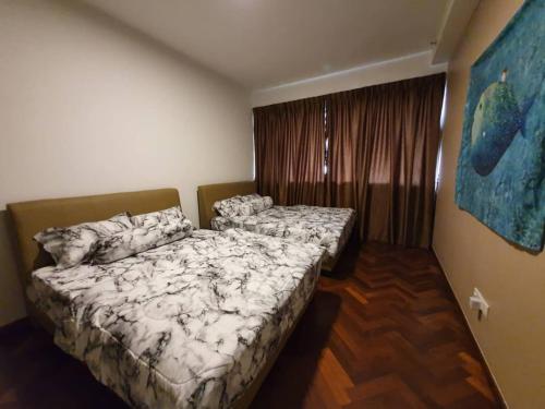 a bedroom with two beds and a window at Landmark By Katana 4BR Romantic Seaview Homestay Gurney无敌海景四房套房 in Tanjong Tokong