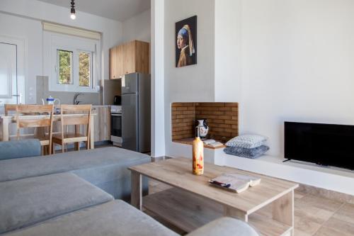 a living room with a couch and a tv and a table at Ble on Blue in Athanion