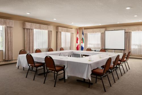 a large meeting room with a large table and chairs at Nova Inn Yellowknife in Yellowknife