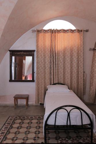 a bedroom with a bed and a mirror in a room at Grandparents' House in Bethlehem
