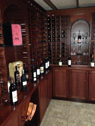 a room with a bunch of bottles of wine on a counter at Tio Pepe’s Guest House in Aibonito