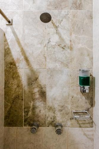 a bathroom with a shower with a stone wall at Private Villa 10 Rooms, Private Pool, Walk to Beach in Playa del Carmen