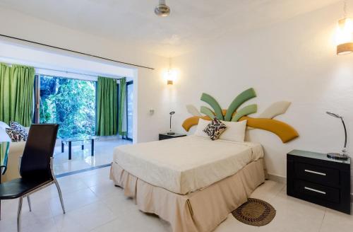 a bedroom with a bed and a desk and a window at Private Villa 10 Rooms, Private Pool, Walk to Beach in Playa del Carmen