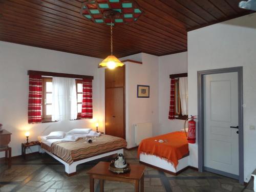a bedroom with two beds and a wooden ceiling at Villa Enallaxis in Agios Dimitrios