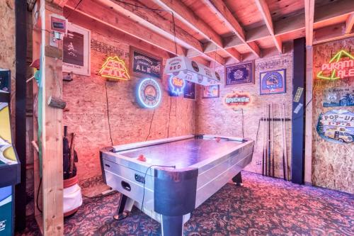 a pool table in a room with signs on the wall at Getaway Bar on Easy Street in Rockaway Beach