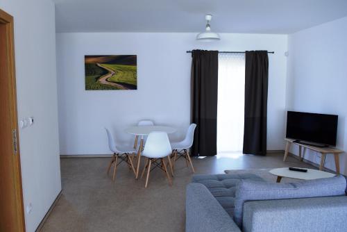 a living room with a couch and a table at Dvůr Perlová voda in Budyně nad Ohří