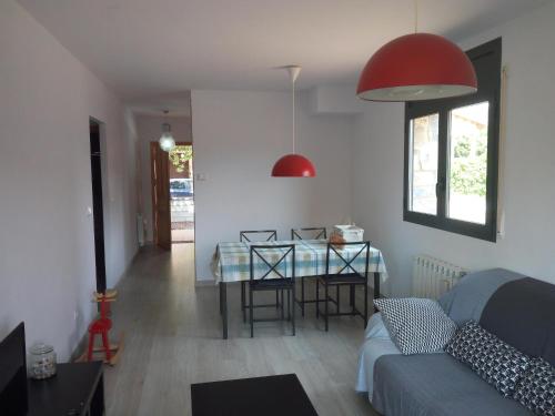 a living room with a table and a couch at Apartamento Paola. Prepirineo. Senderismo, relax... in La Puebla de Castro