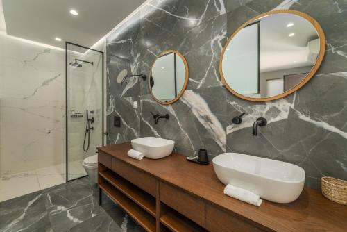 a bathroom with a sink and a mirror at Katouna Suites Luxury Boutique Hotel Adults Only in Lygia