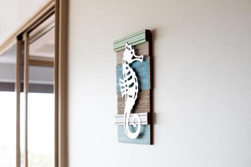 a picture of a seahorse hanging on a door at Getaway Ocean Views in Airlie Beach