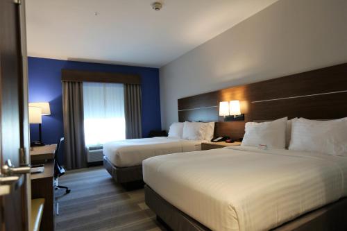 a hotel room with two beds and a desk at Holiday Inn Express & Suites Houston NW - Hwy 290 Cypress by IHG in Cypress