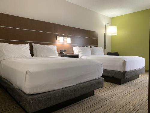 a hotel room with two beds with white pillows at Holiday Inn Express Hillsborough-Durham Area by IHG in Hillsborough