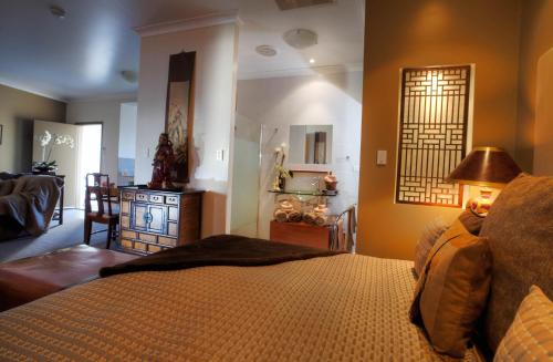a bedroom with a bed and a living room at 53 on Victoria in Warwick