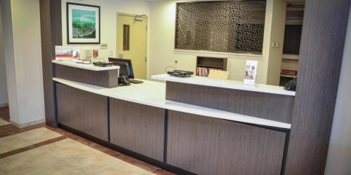 a lobby with a reception desk in a hospital at Candlewood Suites Pearl, an IHG Hotel in Pearl