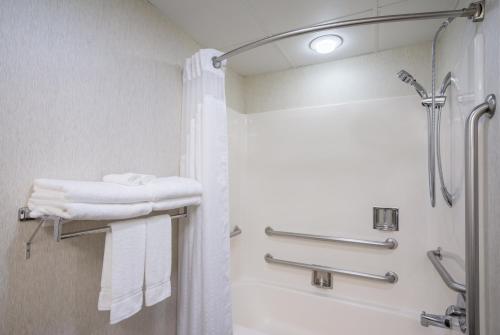 a bathroom with a shower and white towels at Holiday Inn Express Hanover, an IHG Hotel in Hanover