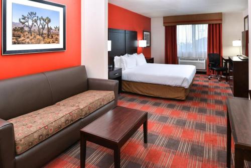 a hotel room with a bed and a couch at Holiday Inn Express Kingman by IHG in Kingman