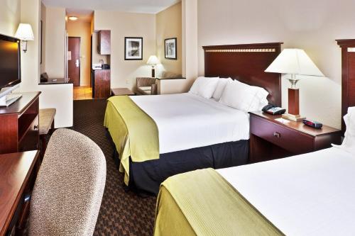 a hotel room with two beds and a desk at Holiday Inn Express & Suites - Miami, an IHG Hotel in Miami