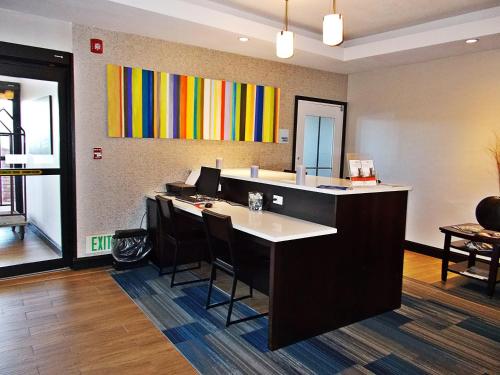 an office with a desk with chairs and a painting on the wall at Route 66 inn & Suites in Miami