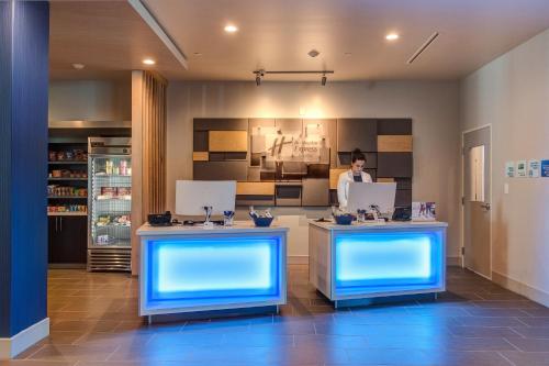 a man in a kitchen with two counters with blue lights at Holiday Inn Express & Suites Gatesville - N. Ft Hood by IHG in Gatesville