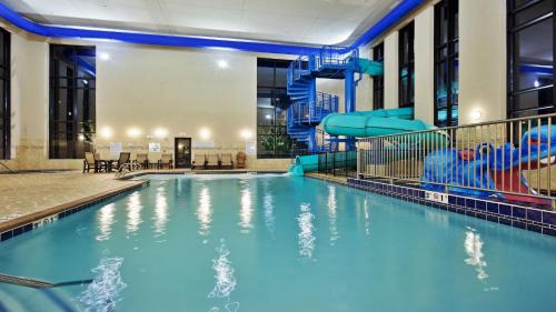 a swimming pool with a slide in a building at Holiday Inn Express and Suites Great Falls, an IHG Hotel in Great Falls
