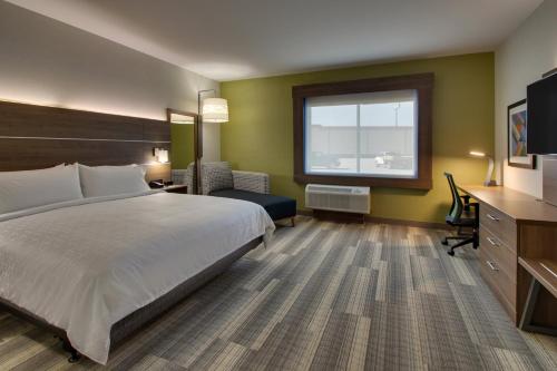 a hotel room with a bed and a desk and a window at Holiday Inn Express - Lexington East - Winchester by IHG in Winchester