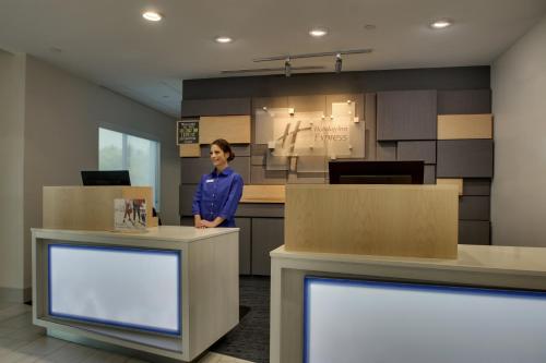 a woman standing at a counter in an office at Holiday Inn Express - Lexington East - Winchester by IHG in Winchester
