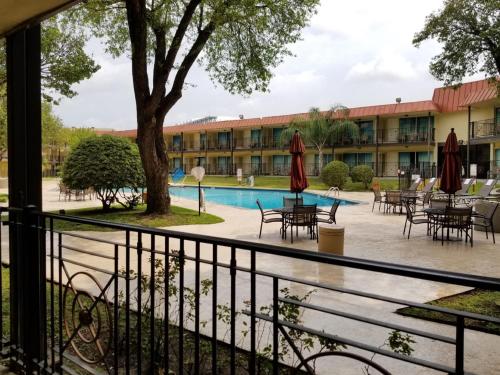 a view from the balcony of a hotel with tables and umbrellas at Wyndham Houston near NRG Park - Medical Center in Houston