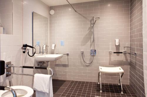 a bathroom with a sink and a shower at Holiday Inn Express - Ringsheim by IHG in Ringsheim